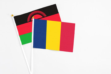 Chad and Malawi stick flags on white background. High quality fabric, miniature national flag....