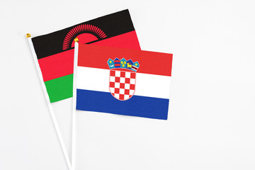 Croatia and Malawi stick flags on white background. High quality fabric, miniature national flag....