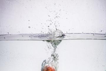 fruit in a spray of water isolated on a white background.