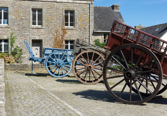 Fototapeta na wymiar picturesque French village of Locronan with old horse-drawn carriages in the foreground