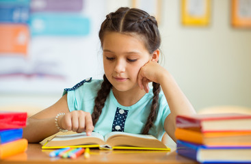 Cute smiling schoolgirl at school