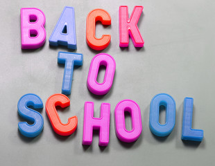 magnetized letters with text Back to School at blackboard