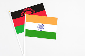 India and Malawi stick flags on white background. High quality fabric, miniature national flag. Peaceful global concept.White floor for copy space.