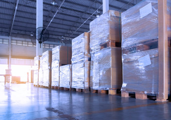 Fototapeta premium Stack of heavy shipment goods in interior of storage warehouse.