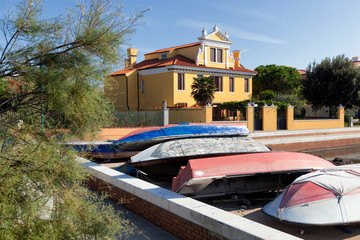 Pellestrina, laguna di Venezia, barche a secco davanti a tipica casa dell'isola.