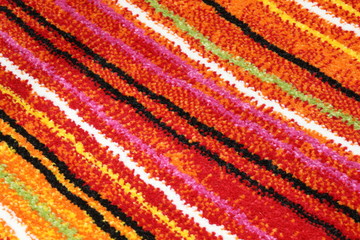 background of a carpet with oblique colored lines