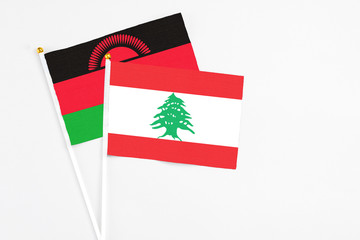 Lebanon and Malawi stick flags on white background. High quality fabric, miniature national flag....