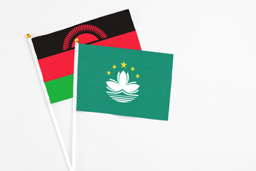 Macao and Malawi stick flags on white background. High quality fabric, miniature national flag. Peaceful global concept.White floor for copy space.