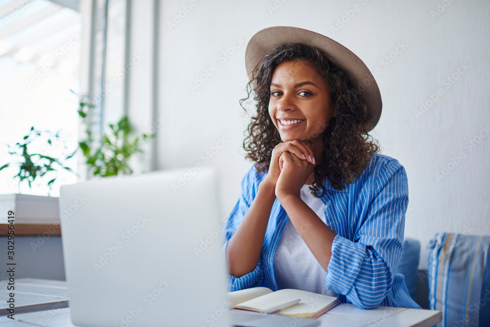 Poster portrait of skilled african american female student using laptop computer for learning and browsing 