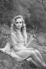  stunning black and white portrait young beautiful girl in a light dress in the garden where magnolias bloom