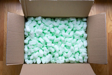 open cardboard box with styrofoam beans