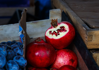 Bunch of plums and pomegranate at market