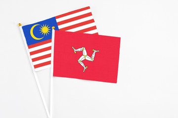 Isle Of Man and Malaysia stick flags on white background. High quality fabric, miniature national...