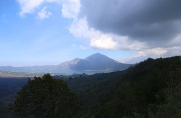 Volcanoes and forests of tropical evergreen island, sky and clouds