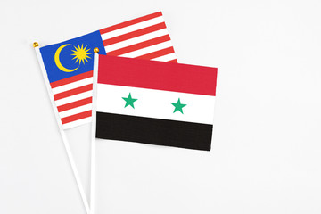 Syria and Malaysia stick flags on white background. High quality fabric, miniature national flag....