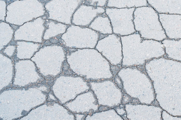 A fragment of cracked old asphalt