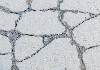 Obraz premium A fragment of cracked old asphalt