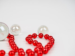 red beads transparent ball lie on a white background