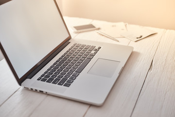Laptop with blank screen on table..