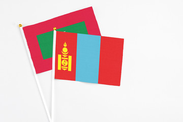 Mongolia and Maldives stick flags on white background. High quality fabric, miniature national flag. Peaceful global concept.White floor for copy space.