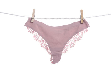 Pink female panties clothespins rope on white background isolation