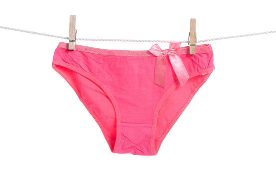 Pink female panties clothespins rope on white background isolation