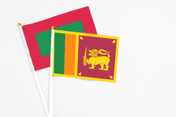 Sri Lanka and Maldives stick flags on white background. High quality fabric, miniature national flag. Peaceful global concept.White floor for copy space.
