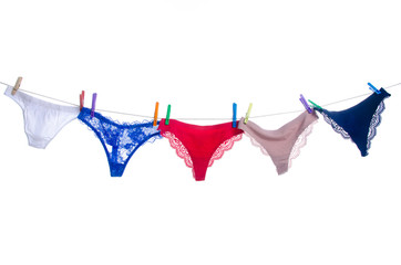female panties on clothespins rope on white background isolation