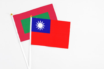 Taiwan and Maldives stick flags on white background. High quality fabric, miniature national flag. Peaceful global concept.White floor for copy space.