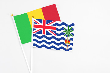 Fototapeta premium British Indian Ocean Territory and Mali stick flags on white background. High quality fabric, miniature national flag. Peaceful global concept.White floor for copy space.