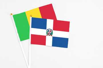 Dominican Republic and Mali stick flags on white background. High quality fabric, miniature national flag. Peaceful global concept.White floor for copy space.