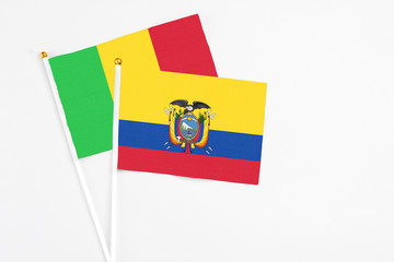 Ecuador and Mali stick flags on white background. High quality fabric, miniature national flag. Peaceful global concept.White floor for copy space.