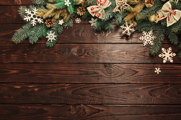 fir branches with Christmas decor on old dark wooden background