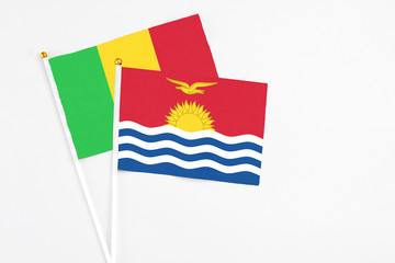 Kiribati and Mali stick flags on white background. High quality fabric, miniature national flag. Peaceful global concept.White floor for copy space.