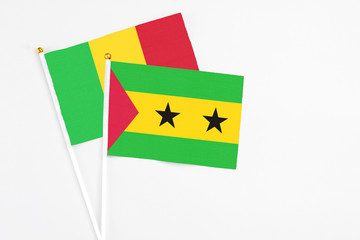 Sao Tome And Principe and Mali stick flags on white background. High quality fabric, miniature national flag. Peaceful global concept.White floor for copy space.