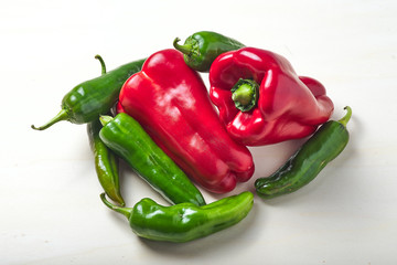 Isolated red and green peppers on a white background