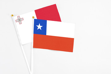 Chile and Malta stick flags on white background. High quality fabric, miniature national flag. Peaceful global concept.White floor for copy space.