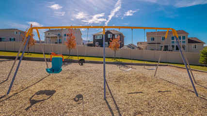 Panorama Deserted A-frame kids swings on a playground