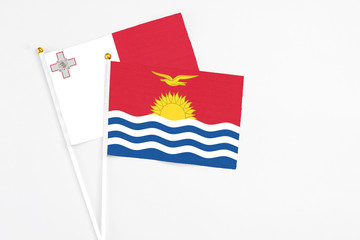 Kiribati and Malta stick flags on white background. High quality fabric, miniature national flag. Peaceful global concept.White floor for copy space.