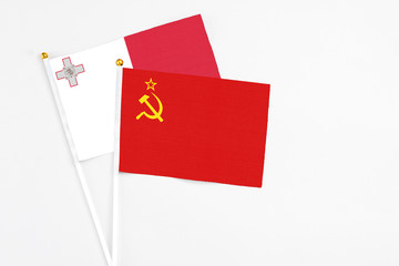 Soviet Union and Malta stick flags on white background. High quality fabric, miniature national flag. Peaceful global concept.White floor for copy space.