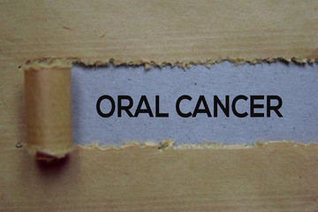 Oral Cancer Text written in torn paper. Medical concept