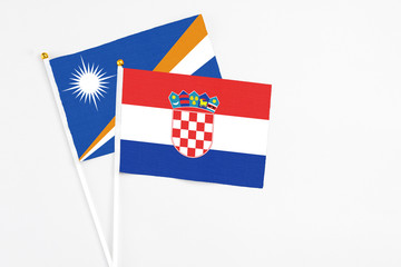 Croatia and Marshall Islands stick flags on white background. High quality fabric, miniature...