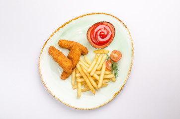 Fototapeta na wymiar Small kid's meal. A plate of chicken nuggets with french fries with ketchup on a white background. Top view children's menu food