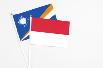 Indonesia and Marshall Islands stick flags on white background. High quality fabric, miniature national flag. Peaceful global concept.White floor for copy space.