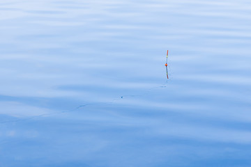 fishing float blue water smooth surface background empty copy space for your text here 