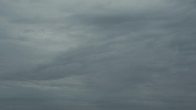 Time lapse of ominous dark grey storm clouds forming in the sky