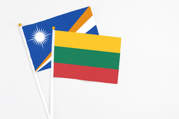Lithuania and Marshall Islands stick flags on white background. High quality fabric, miniature national flag. Peaceful global concept.White floor for copy space.