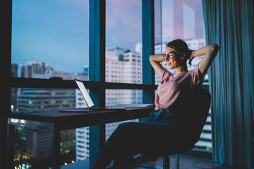 Attractive female freelancer resting after complete work in office on laptop with blank screen....