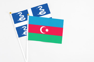 Azerbaijan and Martinique stick flags on white background. High quality fabric, miniature national flag. Peaceful global concept.White floor for copy space.