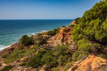 Fototapeta na wymiar Colorful orange cliffs at Praia da Falesia, Portugal.